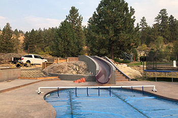 Finished concrete pool deck slide and stairs